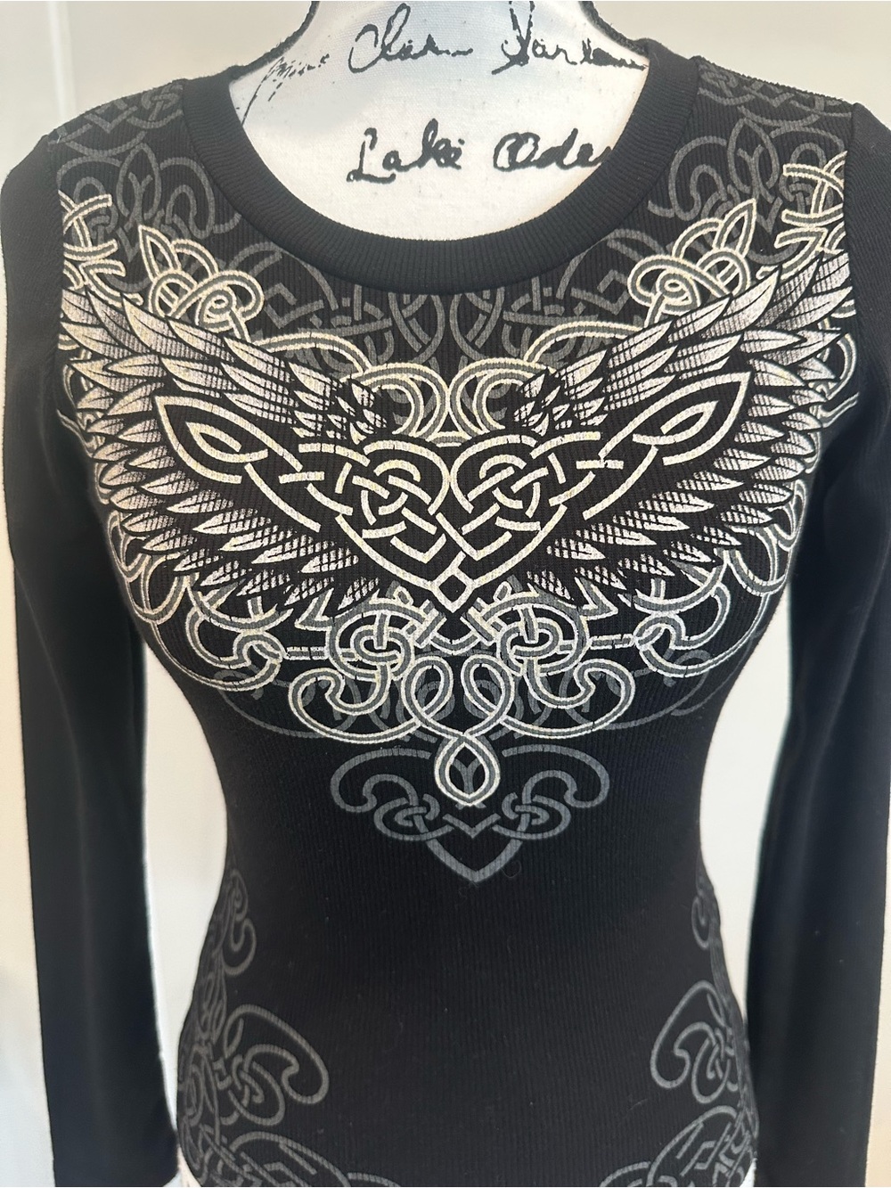Black Long-Sleeve Graphic Tee with Silver Celtic Wing Motif.FITS LIKE AN XS.